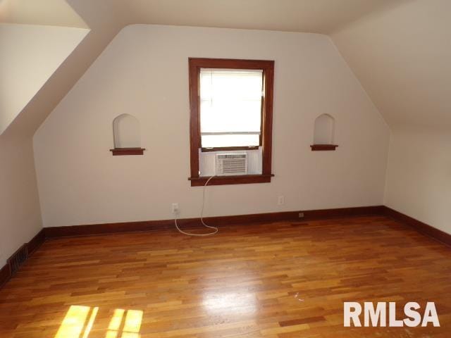 1522 Brady St, Davenport, IA 52803 - bonus room featuring vaulted ceiling, light wood-type flooring, cooling unit, and baseboards