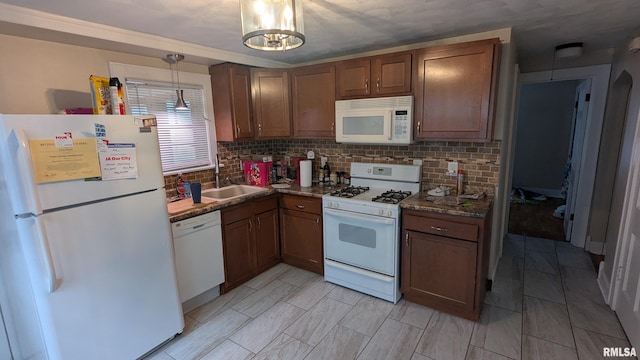 1522 Brady St, Davenport, IA 52803 - kitchen with white appliances, a sink, tasteful backsplash, brown cabinetry, and pendant lighting