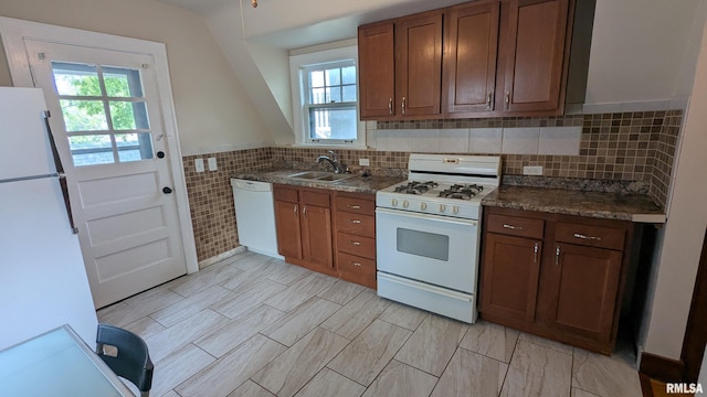 1522 Brady St, Davenport, IA 52803 - kitchen with white appliances, healthy amount of natural light, a sink, dark countertops, and tile walls