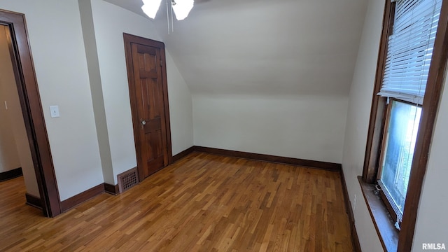 1522 Brady St, Davenport, IA 52803 - bonus room with wood finished floors, vaulted ceiling, baseboards, and a ceiling fan