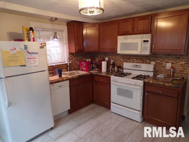 1522 Brady St, Davenport, IA 52803 - kitchen featuring white appliances, backsplash, a sink, and brown cabinets