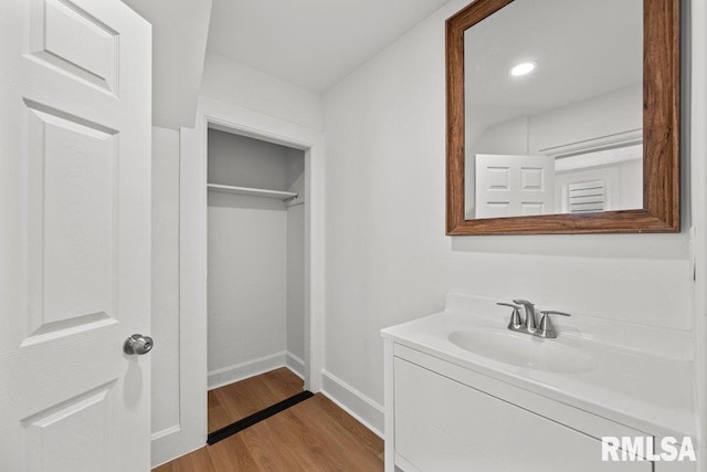 2025 W 3rd St, Davenport, IA 52802 - bathroom featuring wood finished floors, vanity, baseboards, and recessed lighting
