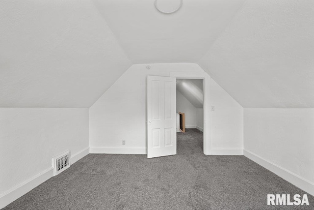 2025 W 3rd St, Davenport, IA 52802 - additional living space featuring carpet floors, lofted ceiling, and baseboards