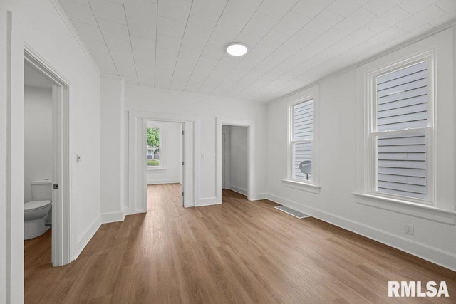 2025 W 3rd St, Davenport, IA 52802 - unfurnished bedroom featuring wood finished floors, crown molding, and baseboards