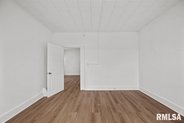 2025 W 3rd St, Davenport, IA 52802 - empty room with ornamental molding, wood finished floors, and baseboards