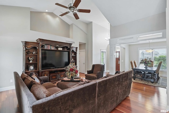 7 Redstone Ct, Le Claire, IA 52753 - living room featuring ceiling fan, hardwood / wood-style floors, baseboards, and high vaulted ceiling