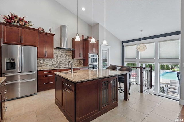 7 Redstone Ct, Le Claire, IA 52753 - kitchen with stainless steel appliances, high vaulted ceiling, island range hood, tasteful backsplash, and a kitchen island with sink