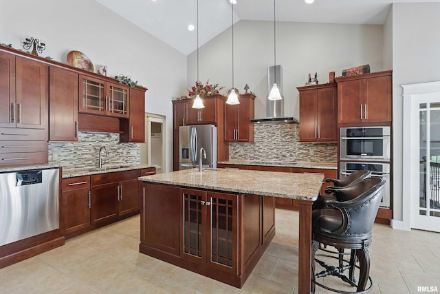 7 Redstone Ct, Le Claire, IA 52753 - kitchen with stainless steel appliances, wall chimney range hood, a sink, high vaulted ceiling, and tasteful backsplash