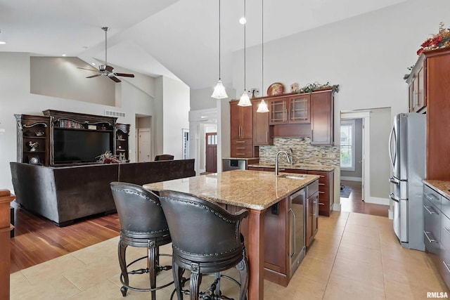7 Redstone Ct, Le Claire, IA 52753 - kitchen with freestanding refrigerator, high vaulted ceiling, a sink, light tile patterned floors, and a ceiling fan