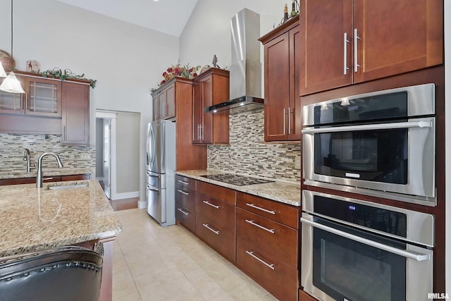 7 Redstone Ct, Le Claire, IA 52753 - kitchen with freestanding refrigerator, a sink, wall chimney range hood, tasteful backsplash, and light stone countertops