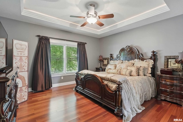 7 Redstone Ct, Le Claire, IA 52753 - bedroom featuring a raised ceiling, wood finished floors, and baseboards