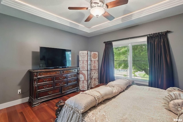 7 Redstone Ct, Le Claire, IA 52753 - bedroom featuring a raised ceiling, dark wood-type flooring, baseboards, and ceiling fan