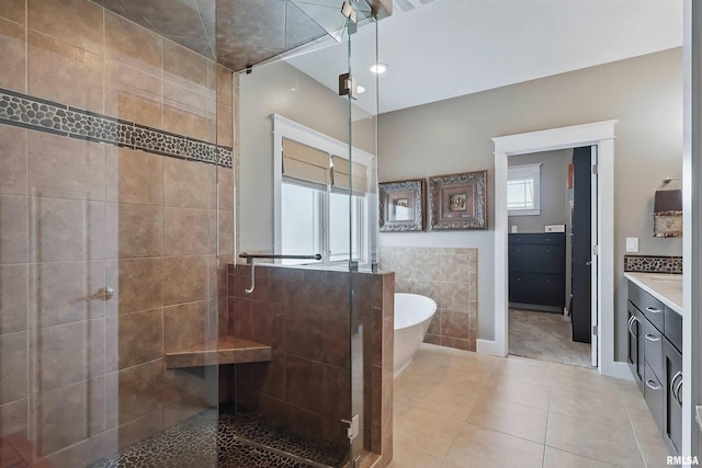 7 Redstone Ct, Le Claire, IA 52753 - full bath with a stall shower, vanity, a freestanding tub, tile patterned floors, and tile walls