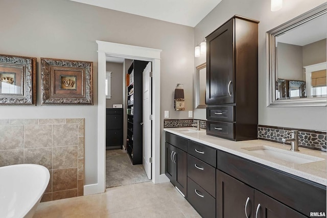 7 Redstone Ct, Le Claire, IA 52753 - bathroom featuring a soaking tub, double vanity, and tile patterned flooring
