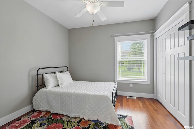 7 Redstone Ct, Le Claire, IA 52753 - bedroom featuring baseboards, wood finished floors, and a ceiling fan