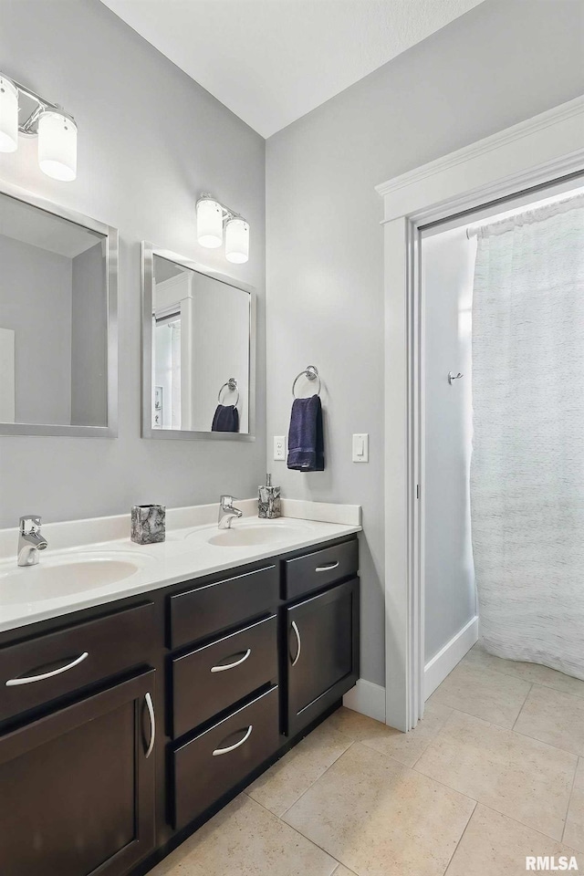 7 Redstone Ct, Le Claire, IA 52753 - bathroom featuring double vanity, baseboards, and tile patterned floors
