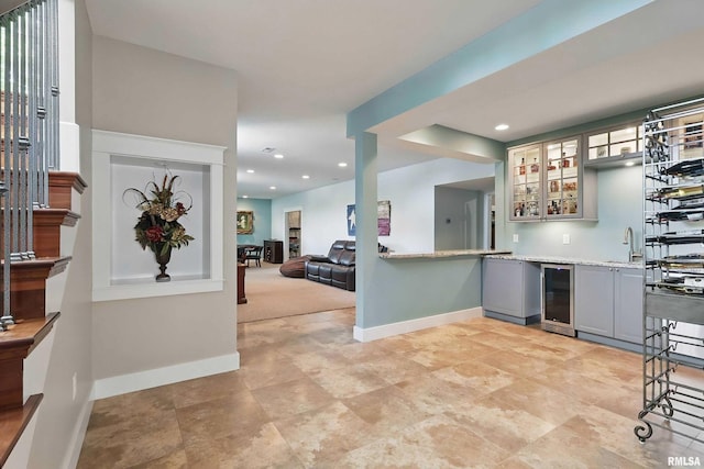 7 Redstone Ct, Le Claire, IA 52753 - kitchen featuring gray cabinetry, wine cooler, baseboards, glass insert cabinets, and a sink