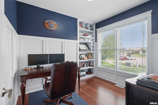 7 Redstone Ct, Le Claire, IA 52753 - home office with a decorative wall, dark wood finished floors, built in shelves, and wainscoting
