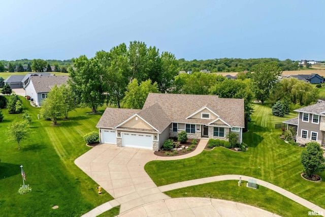 7 Redstone Ct, Le Claire, IA 52753 - view of front of house with stone siding, a garage, driveway, and a front lawn