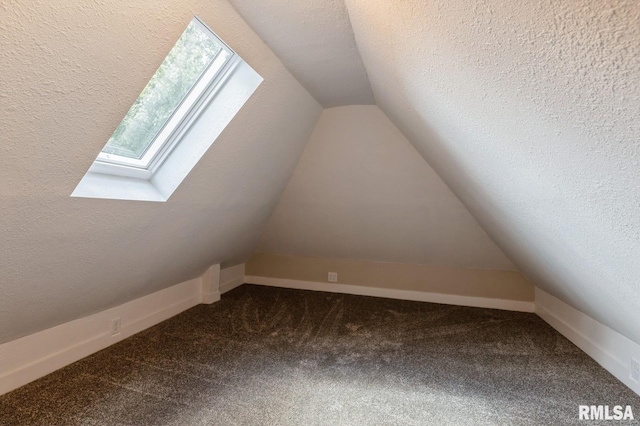 2320 E High St, Davenport, IA 52803 - additional living space with a skylight, lofted ceiling, and carpet flooring