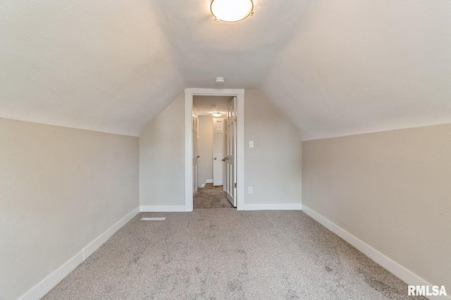 2320 E High St, Davenport, IA 52803 - additional living space featuring carpet floors, lofted ceiling, and baseboards
