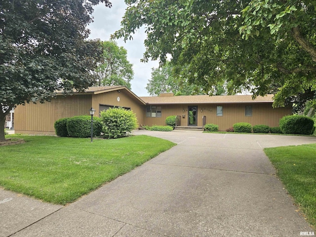 2120 Fareway Dr, Muscatine, IA 52761 - ranch-style house featuring concrete driveway, a front lawn, and an attached garage