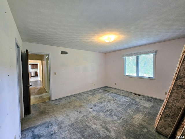 2120 Fareway Dr, Muscatine, IA 52761 - unfurnished bedroom featuring carpet flooring and a textured ceiling