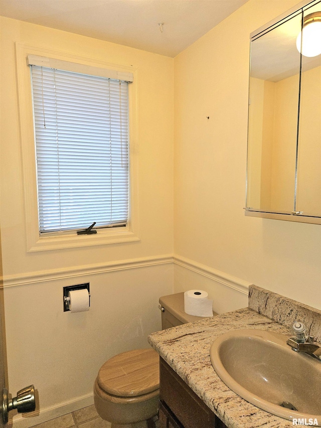2120 Fareway Dr, Muscatine, IA 52761 - bathroom with vanity, toilet, baseboards, and tile patterned floors