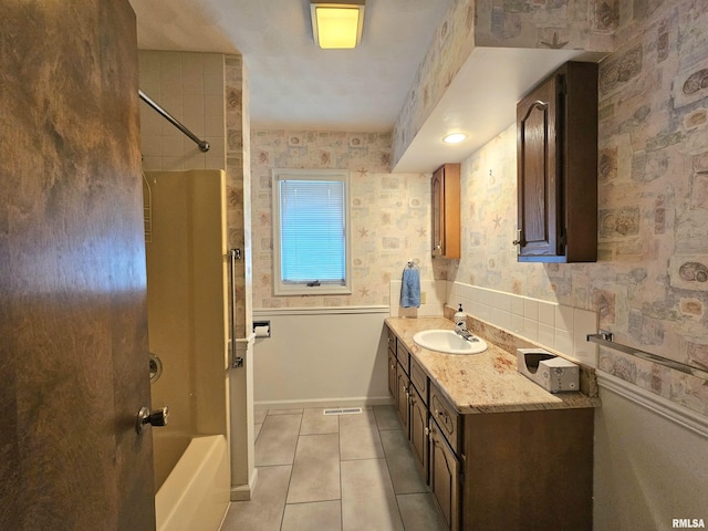 2120 Fareway Dr, Muscatine, IA 52761 - bathroom with tile patterned floors, vanity, bathing tub / shower combination, and wallpapered walls