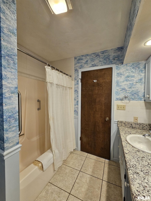 2120 Fareway Dr, Muscatine, IA 52761 - bathroom featuring tile patterned flooring, vanity, shower / bath combo with shower curtain, and wallpapered walls