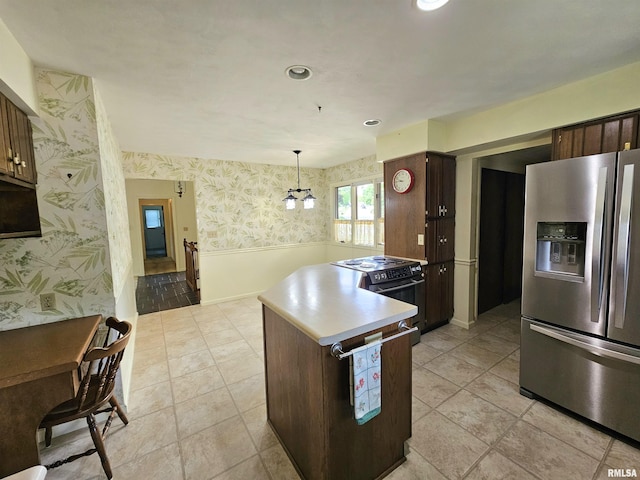 2120 Fareway Dr, Muscatine, IA 52761 - kitchen featuring stainless steel refrigerator with ice dispenser, wallpapered walls, black electric range, wainscoting, and a peninsula
