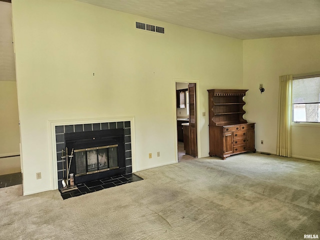 2120 Fareway Dr, Muscatine, IA 52761 - unfurnished living room with carpet flooring, a fireplace, and a towering ceiling