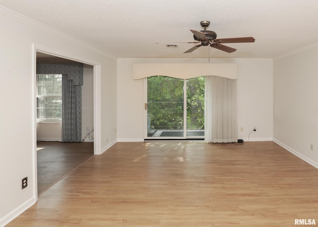 1360 Kimberly Ridge Rd Unit 313, Bettendorf, IA 52722 - spare room with a ceiling fan, ornamental molding, light wood-style flooring, and a textured ceiling