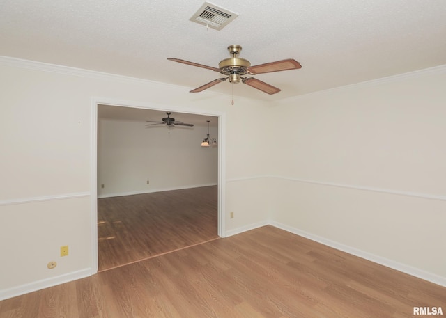 1360 Kimberly Ridge Rd Unit 313, Bettendorf, IA 52722 - empty room with a ceiling fan, wood finished floors, and ornamental molding