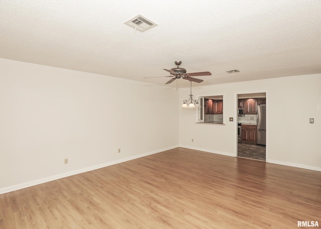 1360 Kimberly Ridge Rd Unit 313, Bettendorf, IA 52722 - unfurnished room featuring light wood-type flooring, a ceiling fan, ornamental molding, a textured ceiling, and a chandelier