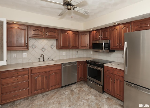 1360 Kimberly Ridge Rd Unit 313, Bettendorf, IA 52722 - kitchen featuring appliances with stainless steel finishes, light countertops, ceiling fan, and backsplash