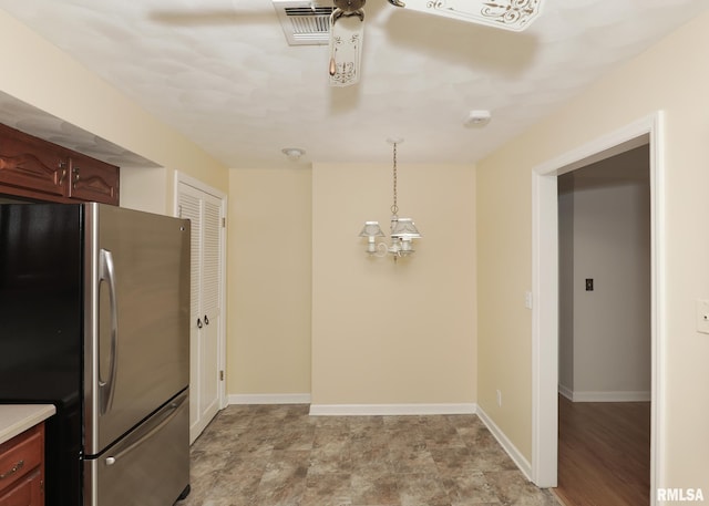 1360 Kimberly Ridge Rd Unit 313, Bettendorf, IA 52722 - kitchen with freestanding refrigerator, light countertops, and pendant lighting