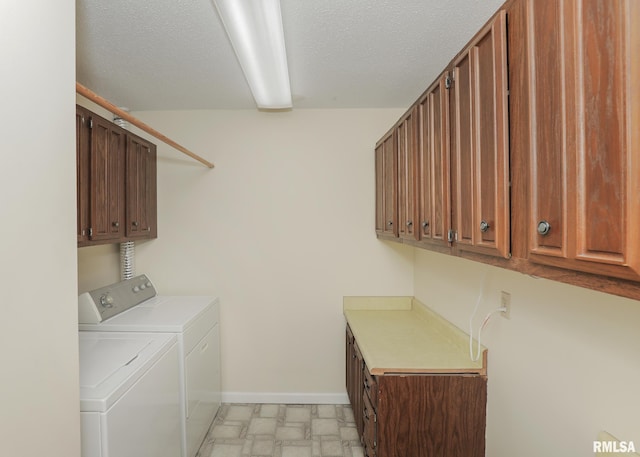1360 Kimberly Ridge Rd Unit 313, Bettendorf, IA 52722 - washroom featuring cabinet space, washing machine and clothes dryer, and a textured ceiling
