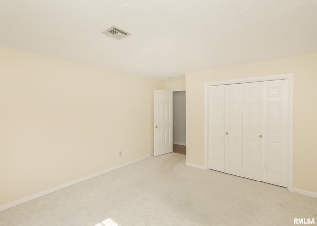 1360 Kimberly Ridge Rd Unit 313, Bettendorf, IA 52722 - unfurnished bedroom featuring light colored carpet and a closet