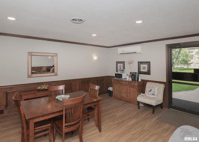 1360 Kimberly Ridge Rd Unit 313, Bettendorf, IA 52722 - dining area with a wall mounted air conditioner, crown molding, light wood-style floors, and recessed lighting