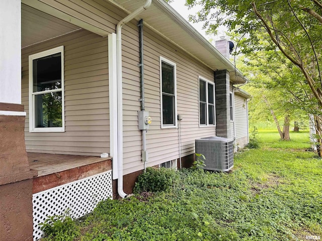 210 SE Front St, Dongola, IL 62926 - view of property exterior featuring cooling unit and a chimney