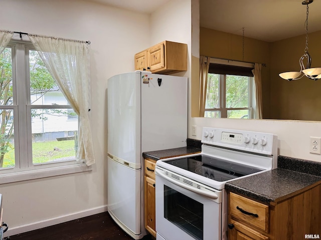 210 SE Front St, Dongola, IL 62926 - kitchen featuring white appliances, dark countertops, baseboards, dark wood-style flooring, and decorative light fixtures