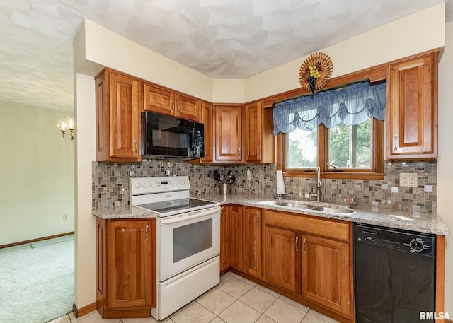 1523 7th St, Orion, IL 61273 - kitchen with black appliances, a sink, brown cabinetry, backsplash, and light stone countertops