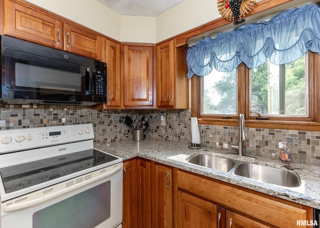 1523 7th St, Orion, IL 61273 - kitchen with white electric stove, black microwave, a sink, and brown cabinets