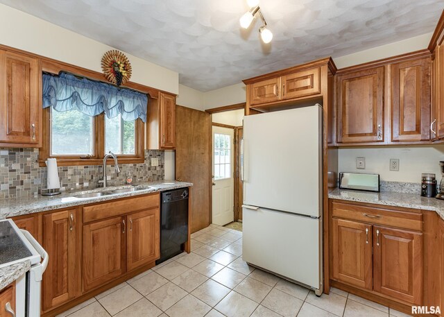 1523 7th St, Orion, IL 61273 - kitchen featuring white appliances, a sink, brown cabinetry, tasteful backsplash, and light tile patterned flooring