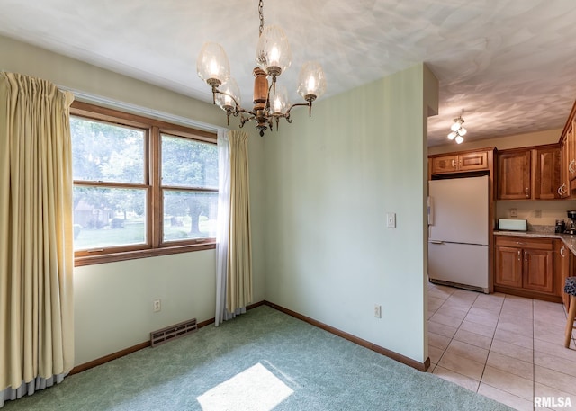 1523 7th St, Orion, IL 61273 - unfurnished dining area with a chandelier, baseboards, and light carpet