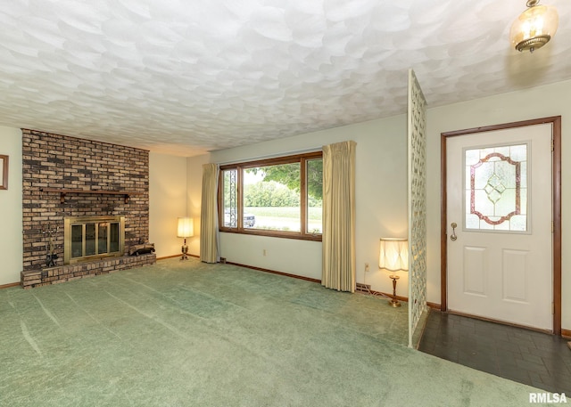 1523 7th St, Orion, IL 61273 - unfurnished living room with baseboards, a brick fireplace, and a textured ceiling
