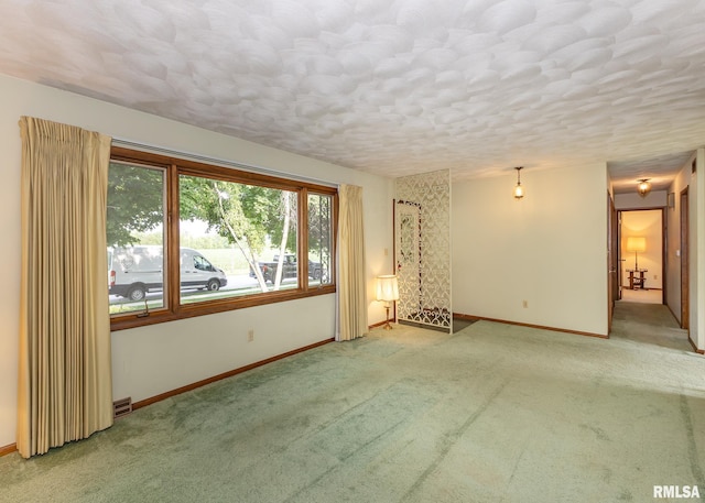 1523 7th St, Orion, IL 61273 - carpeted empty room featuring baseboards and a textured ceiling
