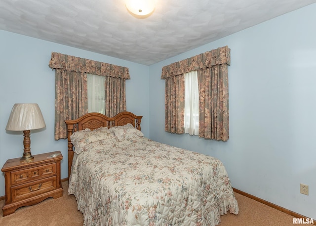 1523 7th St, Orion, IL 61273 - bedroom featuring light carpet, baseboards, and multiple windows