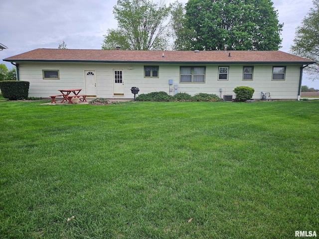 1523 7th St, Orion, IL 61273 - rear view of house featuring a lawn and central AC unit